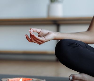 Close-up of hands in a yoga mudra.